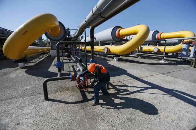 A worker turns a valve at an underground gas storage facility near Striy