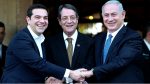 Cypriot president Nicos Anastasides, centre, Greek Prime Minister Alexis Tsipras, left, and Israeli Prime Minister Benjamin Netanyahu shake hands after leaving their meeting from the presidential palace in capital Nicosia in the Mediterranean island of Cyprus, Thursday, Jan. 28, 2016. The leaders of Cyprus, Greece and Israel met in the Cypriot capital with the aim to strengthen cooperation and bolster stability in a region wracked by conflict. The talks are the first tripartite summit. Discussions will cover newly found offshore gas reserves and tourism, while the leaders will sign a cooperation agreement on water resources. (AP Photo/Petros Karadjias)