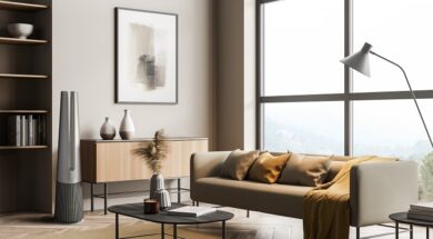 Light living room interior with sofa and drawer with mockup poster near window
