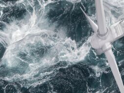 Aerial panorama of a close up wind turbine in the sea
