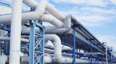 Closeup of industrial pipelines around a factor on a sunny day