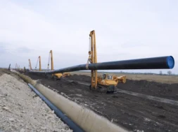 heavy-duty-construction-machines-carrying-placing-gas-pipe-into-ground-800-px