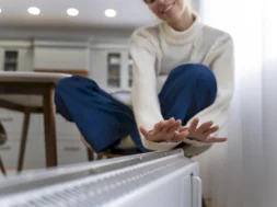 smiley-woman-sitting-near-heater-home-800-px